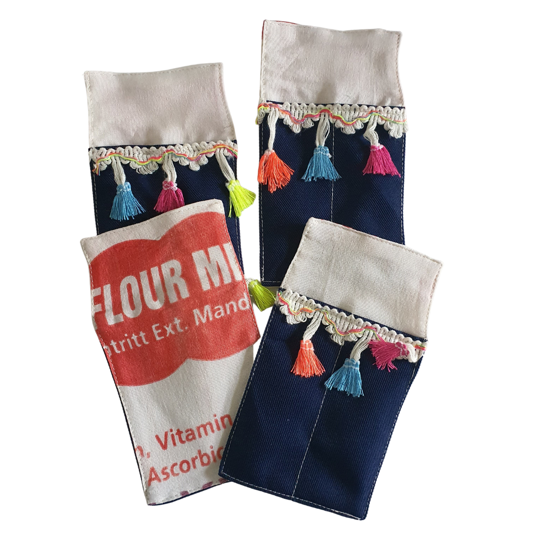 The Gillian Cutlery Set: Set of four cutlery pockets in dark blue with colourful tassels.
