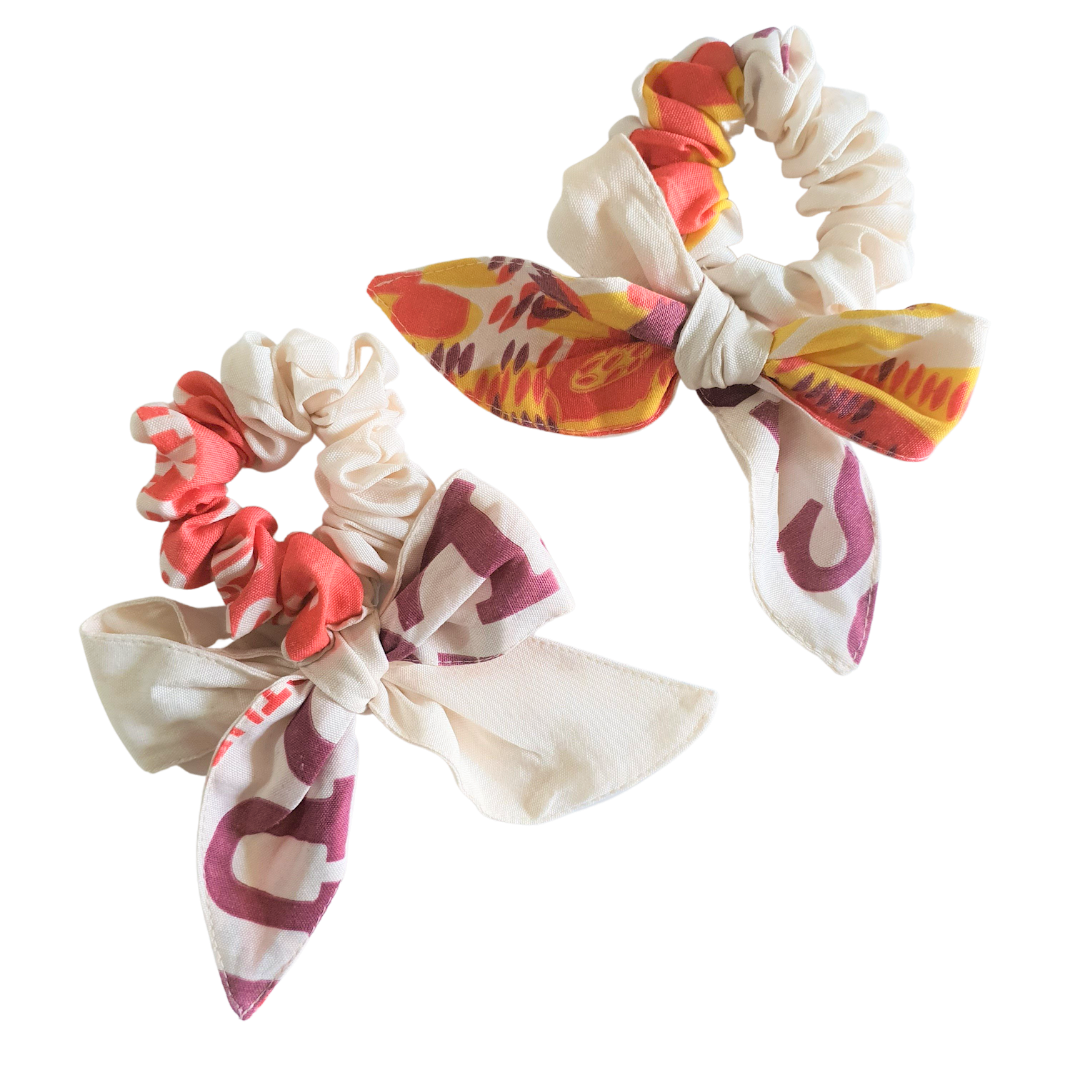 The Sibyl Bow Scrunchie: Oversized curved bow scrunchie sewn from upcycled katsa flour-sack fabric.